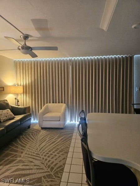 living room featuring radiator heating unit, a ceiling fan, and tile patterned floors