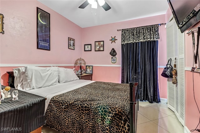 bedroom with ceiling fan and light tile patterned floors