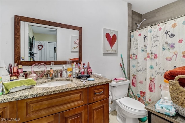 bathroom with a shower with shower curtain, vanity, and toilet