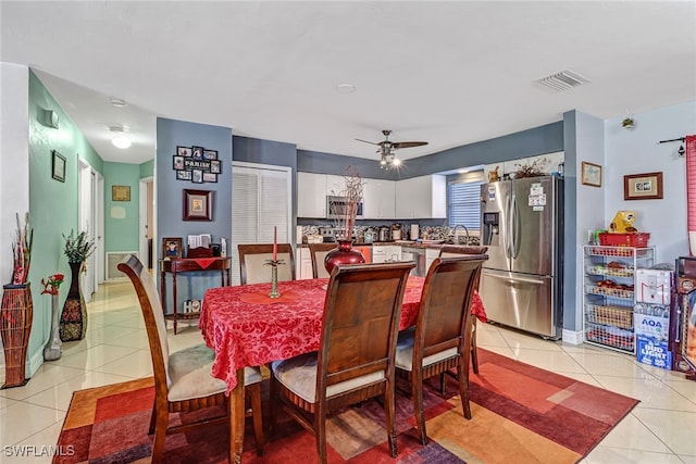 tiled dining room with sink and ceiling fan