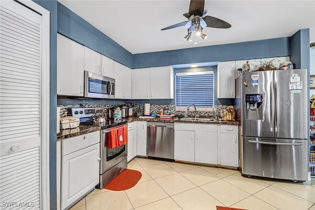 kitchen with white cabinetry, sink, appliances with stainless steel finishes, and tasteful backsplash