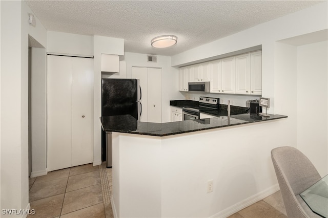 kitchen with stainless steel appliances, light tile patterned flooring, white cabinetry, and kitchen peninsula