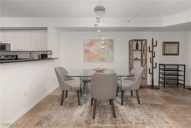 dining room with a textured ceiling and sink