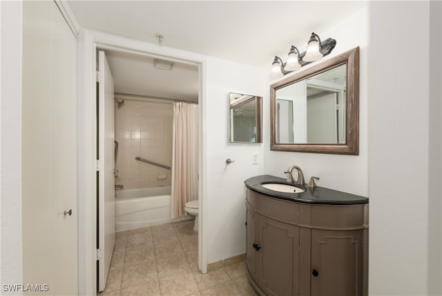 full bathroom with tile patterned flooring, vanity, shower / bath combo with shower curtain, and toilet