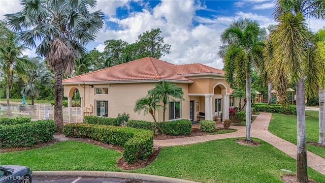 mediterranean / spanish house featuring a front lawn