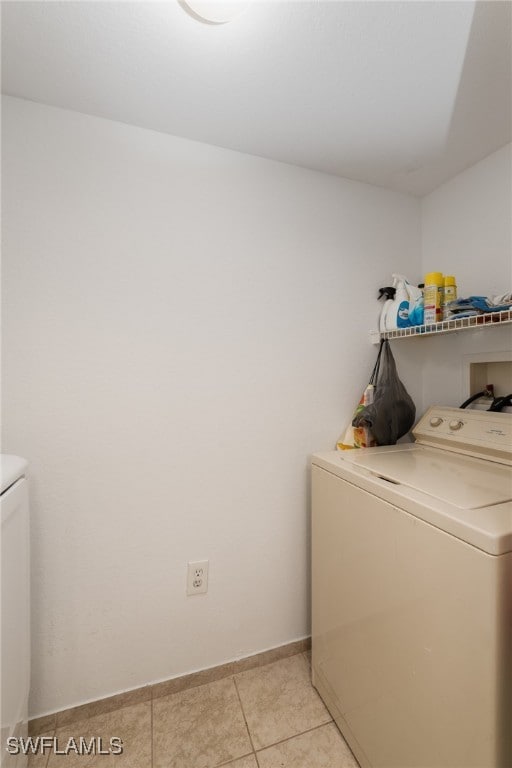 laundry area with independent washer and dryer and light tile patterned flooring