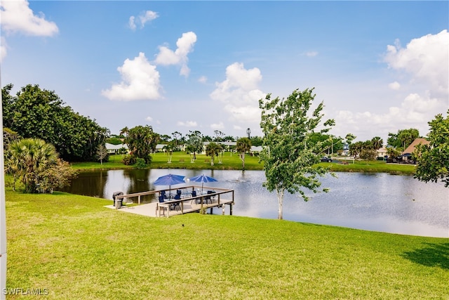 view of dock featuring a yard and a water view