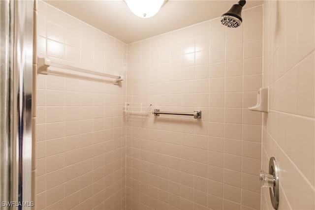 bathroom with tiled shower