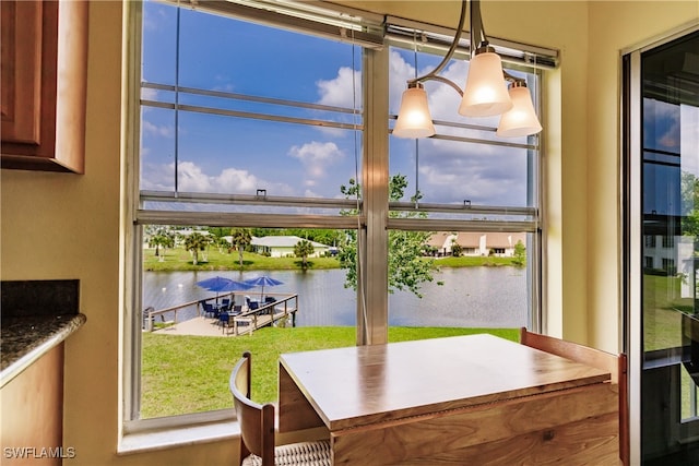 dining area with a chandelier and a water view