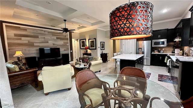 living room with light tile patterned floors, crown molding, ceiling fan, and coffered ceiling