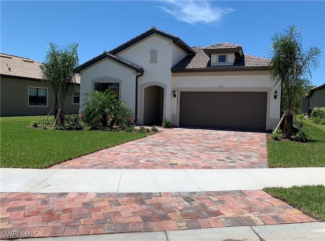 mediterranean / spanish-style home featuring a garage and a front yard