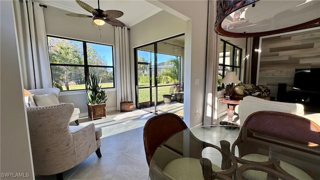 sunroom featuring a ceiling fan