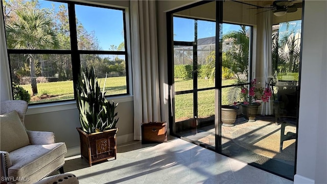 sunroom with ceiling fan and a wealth of natural light