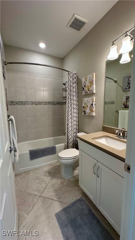 bathroom featuring visible vents, shower / tub combo with curtain, vanity, and toilet