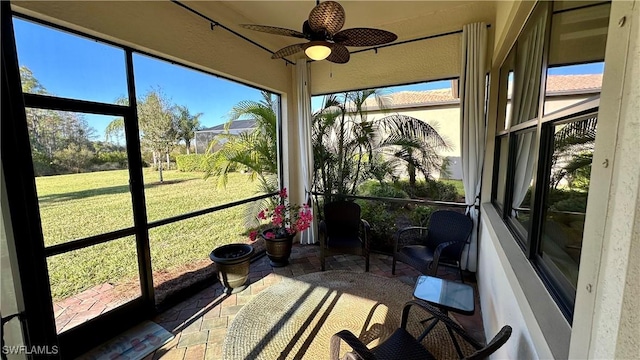 sunroom / solarium with ceiling fan and a healthy amount of sunlight