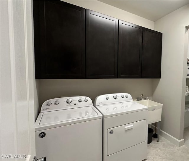 washroom with light tile patterned floors, cabinets, and independent washer and dryer