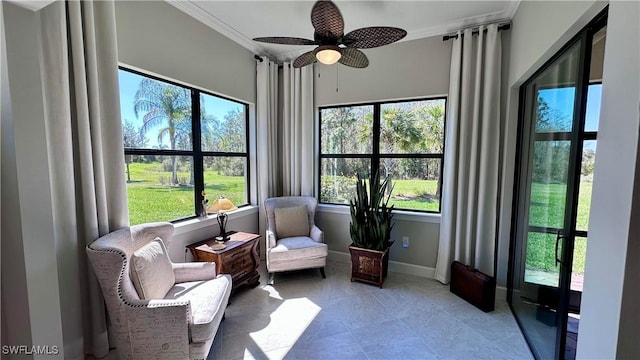 sunroom / solarium featuring a ceiling fan and a wealth of natural light