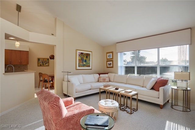 carpeted living room with a water view and lofted ceiling