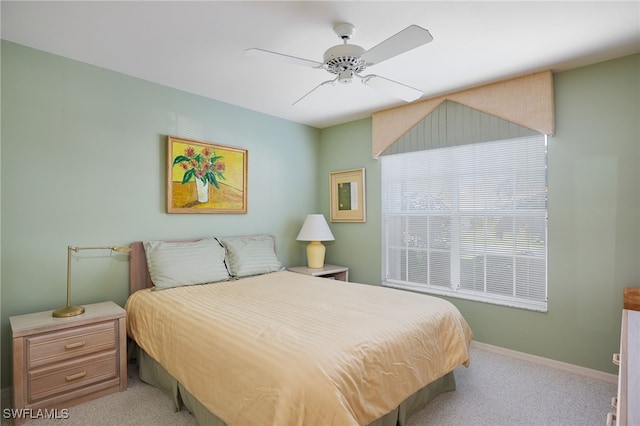 bedroom with ceiling fan and light carpet