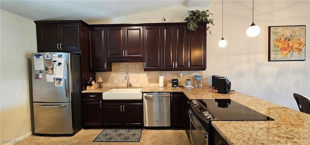 kitchen featuring sink, decorative light fixtures, dark brown cabinets, light tile patterned flooring, and appliances with stainless steel finishes