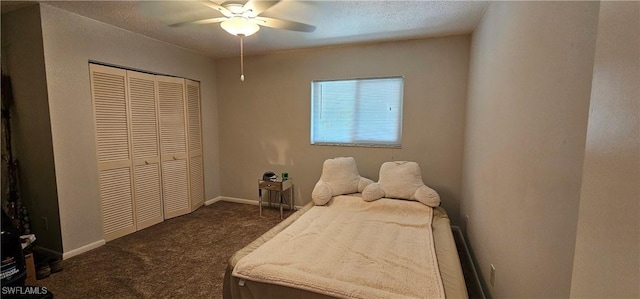 bedroom featuring dark colored carpet, a closet, and ceiling fan