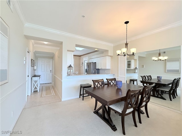 carpeted dining room with crown molding and an inviting chandelier