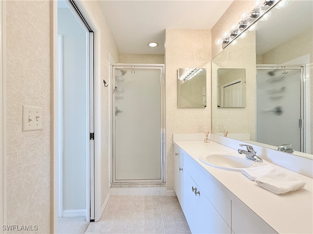 bathroom featuring tile patterned flooring, vanity, and an enclosed shower