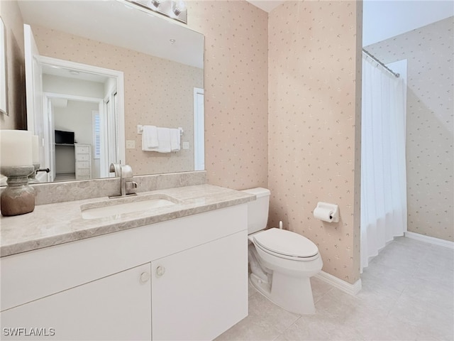 bathroom featuring tile patterned flooring, vanity, and toilet