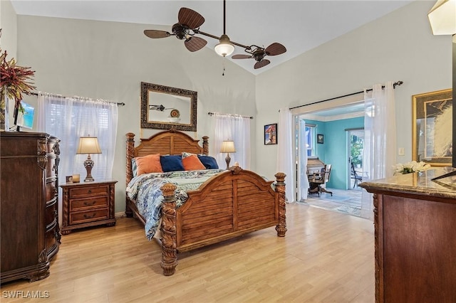 bedroom with access to exterior, light hardwood / wood-style floors, high vaulted ceiling, and ceiling fan