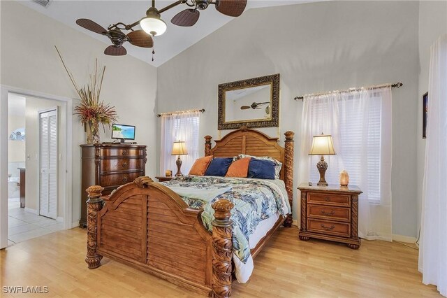 bedroom with multiple windows, ceiling fan, and light hardwood / wood-style flooring