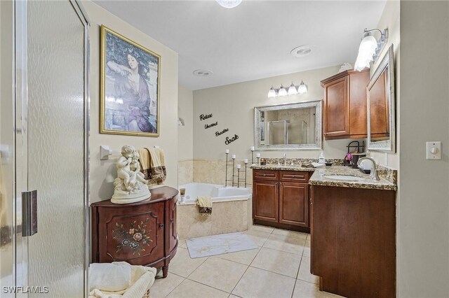 bathroom with tile patterned flooring, vanity, and independent shower and bath