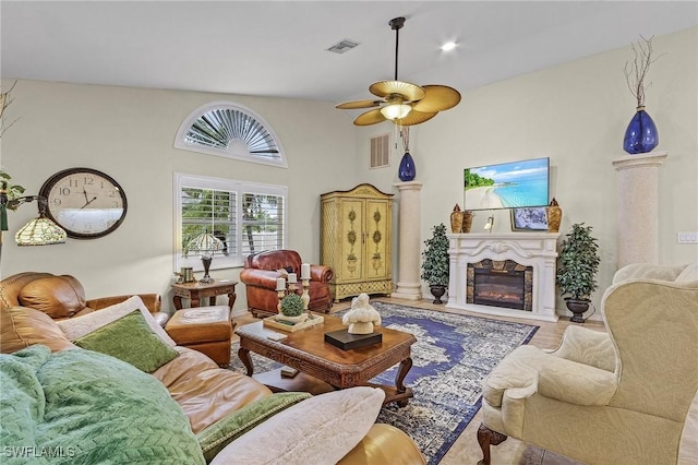 living room featuring a towering ceiling and ceiling fan