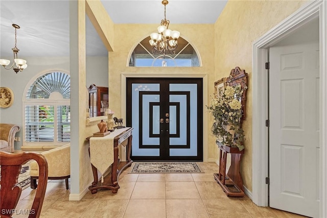 tiled foyer entrance featuring a chandelier