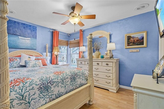 bedroom with ceiling fan and light hardwood / wood-style floors