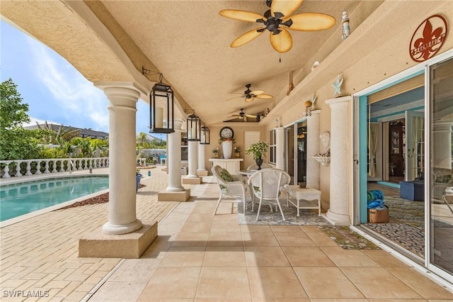 view of patio with a fenced in pool and ceiling fan