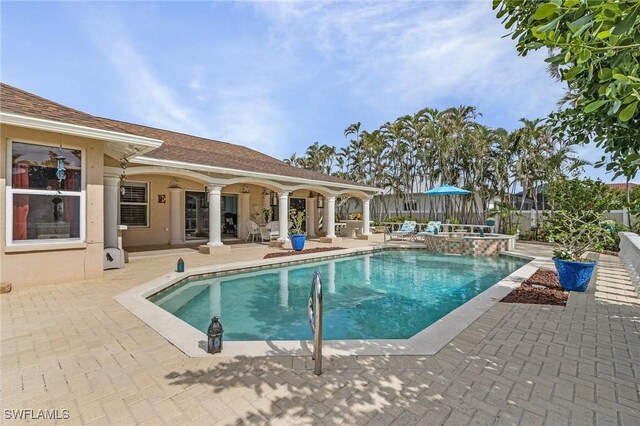 view of pool featuring an in ground hot tub and a patio