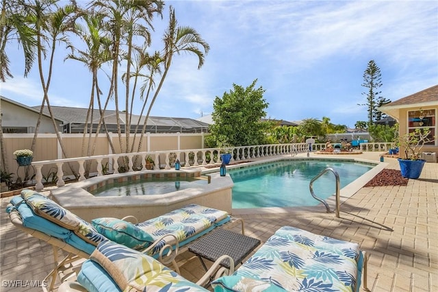 view of pool with an in ground hot tub and a patio