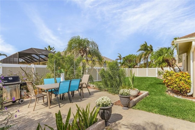 view of patio with a lanai and area for grilling