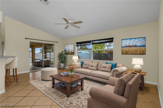 tiled living room featuring ceiling fan and lofted ceiling