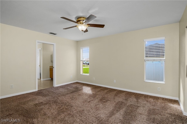 carpeted empty room featuring ceiling fan