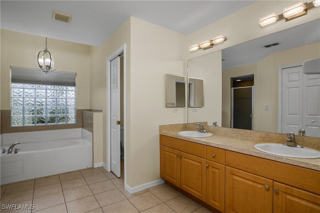 bathroom with a chandelier, vanity, tile patterned flooring, and separate shower and tub