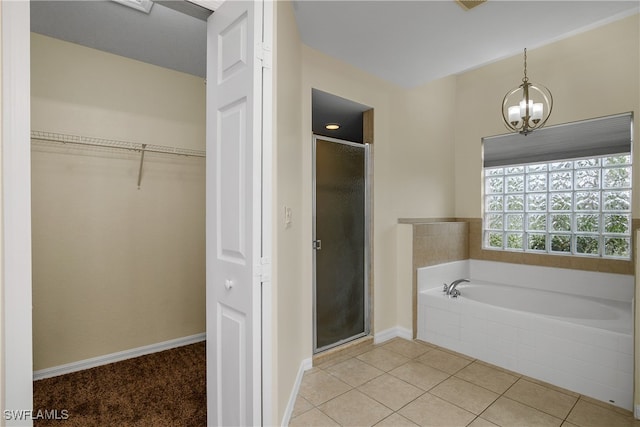 bathroom featuring independent shower and bath, a chandelier, and tile patterned flooring