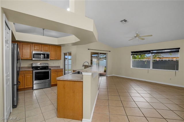 kitchen featuring stainless steel appliances, vaulted ceiling, sink, ceiling fan, and light tile patterned flooring