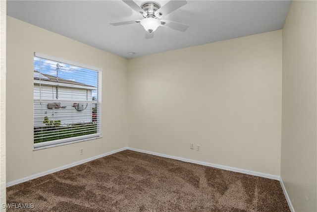 carpeted spare room featuring ceiling fan