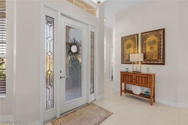 foyer featuring a healthy amount of sunlight and light tile patterned floors