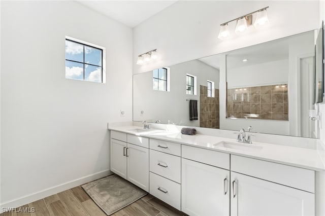 bathroom with vanity and a tile shower