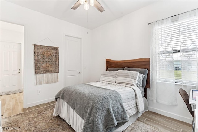 bedroom with ceiling fan and multiple windows