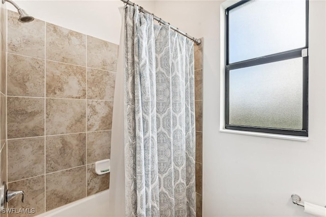 bathroom featuring shower / tub combo with curtain and a wealth of natural light