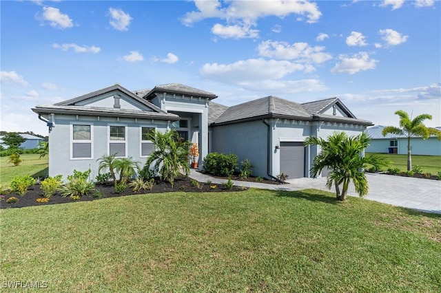 view of front of home with a garage and a front lawn