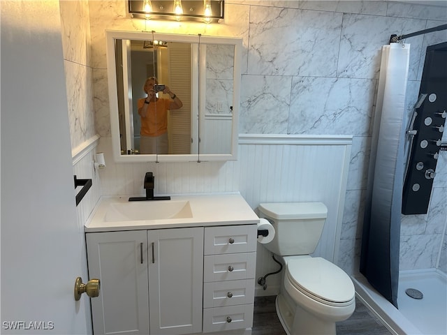 bathroom with toilet, a shower with curtain, vanity, and hardwood / wood-style flooring